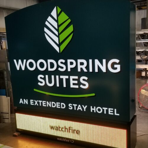 Cabinet Sign with the words Woodspring suites above an extended stay hotel made by Hanson Sign Company