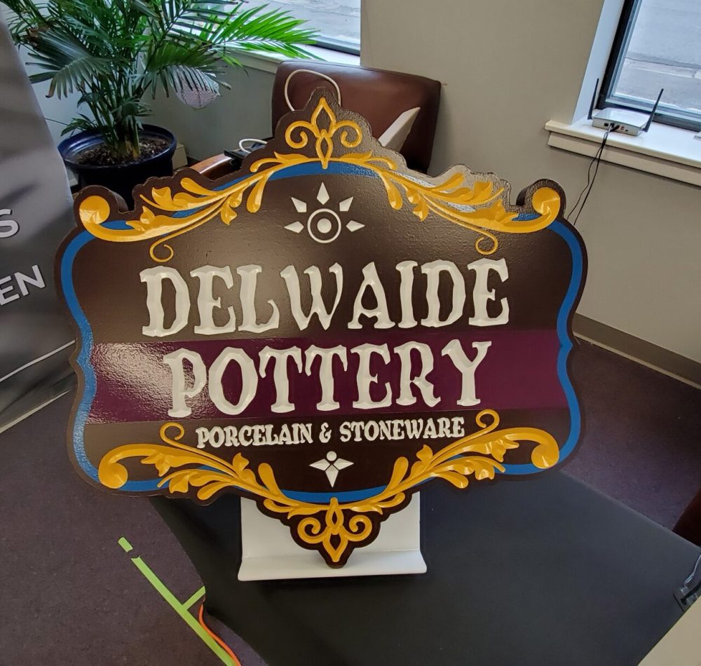 V-grooved carved Dimensional sign with recessed copy and wavy lettering by Hanson Signs Wholesale Sign Manufacturer
